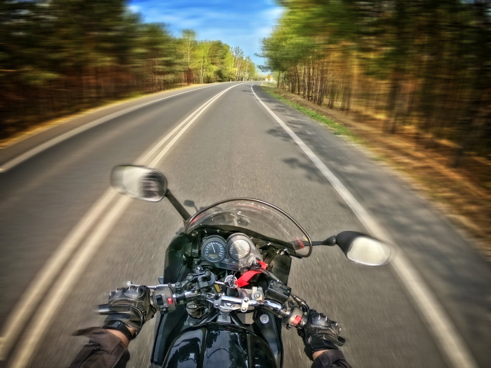 Pines motorcycle accident lawyer reviewing extensive medical reports with a client, planning a personal injury claim to alleviate the financial burden caused by an accident with an at fault driver.