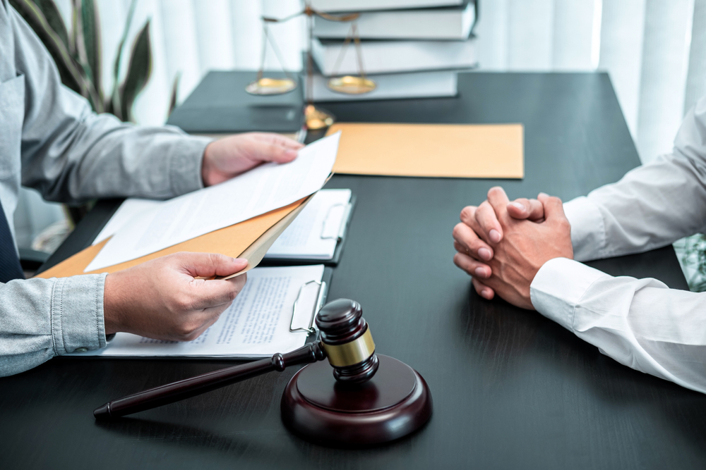Pompano Beach car accident lawyers discussing with a client about a beach car accident case involving serious injuries from a head-on crash and the claims process for financial impact and medical bills.